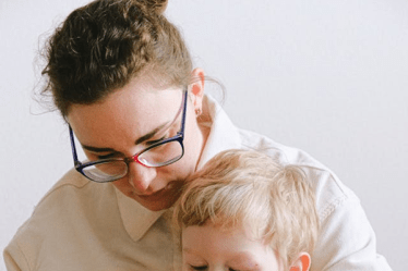 woman bandaging boys hand