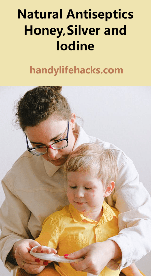 woman bandaging boys hand